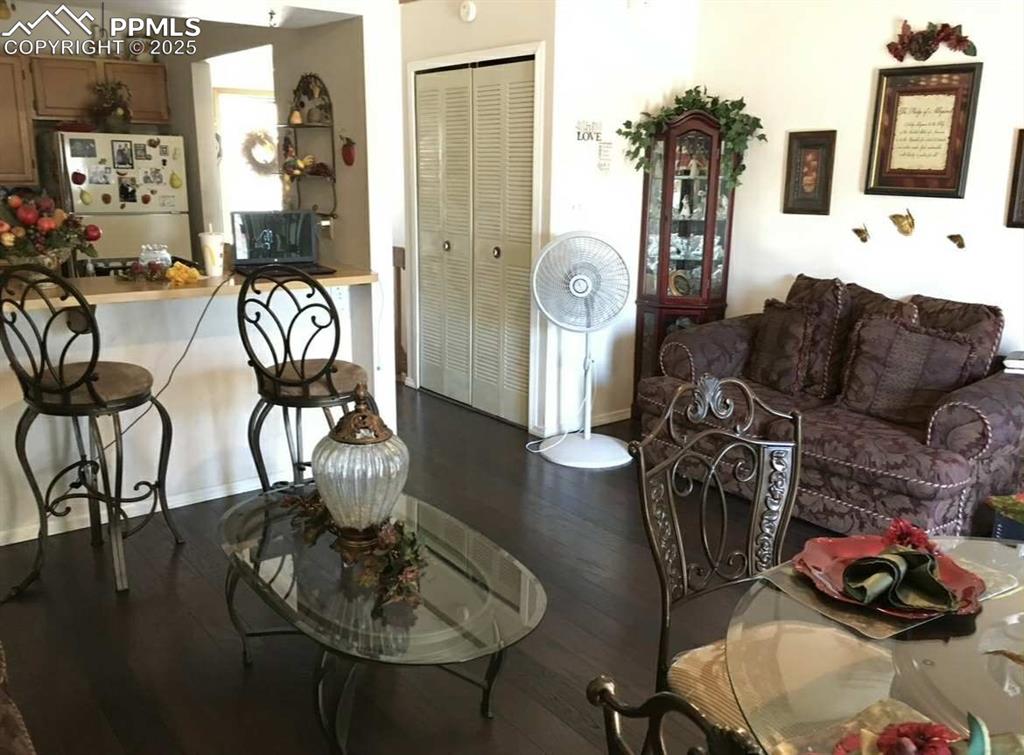 Living room with dark wood finished floors and baseboards