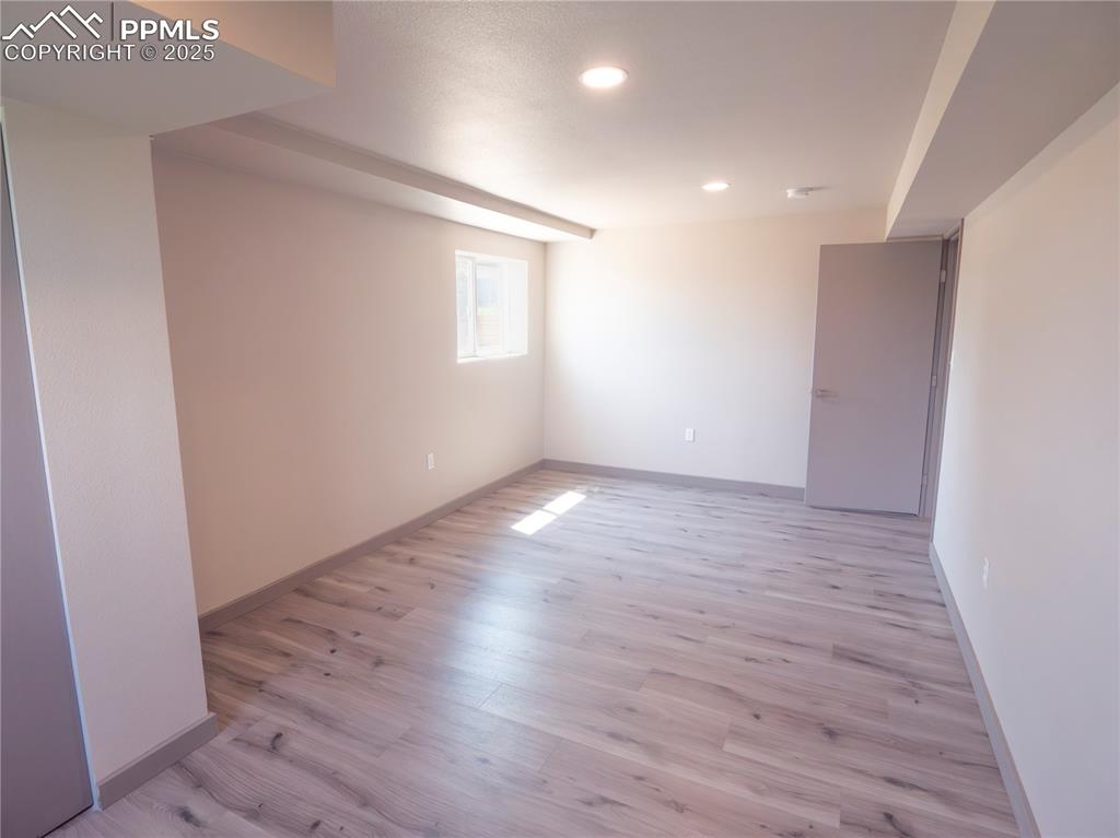 Spare room featuring light wood-style flooring and recessed lighting