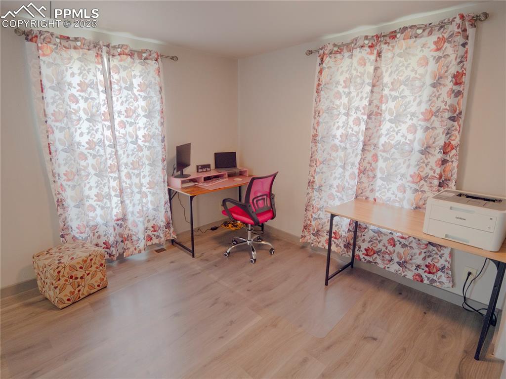 Home office with wood finished floors and baseboards