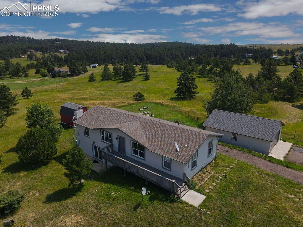 Aerial view of sparsely populated area with a forest