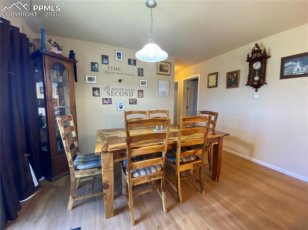 The dining area features direct walkout access to the backyard, enhancing indoor-outdoor living and providing the perfect setting for entertaining with scenic rural views.