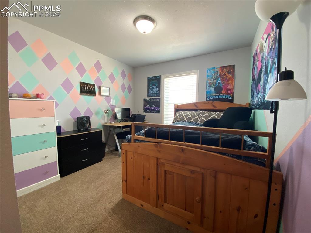 Bright and airy second main-floor bedroom featuring generous space and natural light