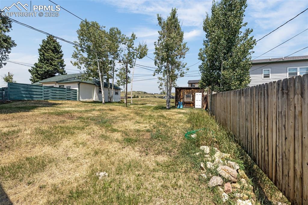 View of yard with a storage unit