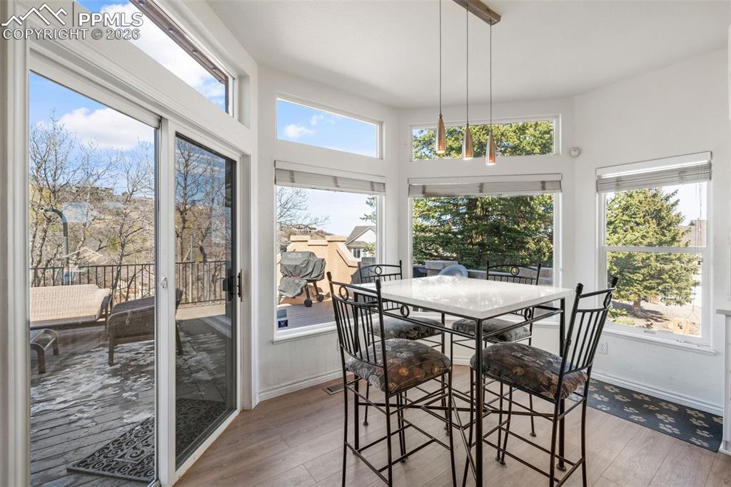 Sunroom with hardwood / wood-style floors