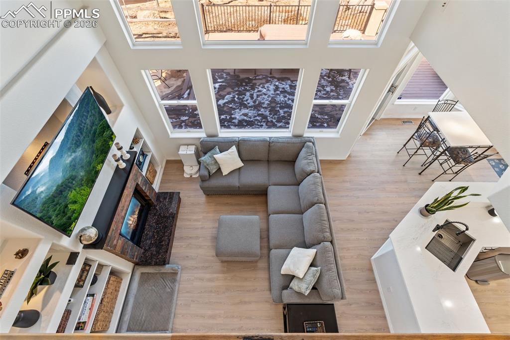 Living area featuring a high ceiling and light wood finished floors