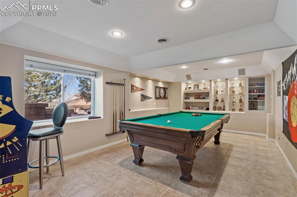 Game room featuring billiards table, built in shelves, light tile patterned floors, and recessed lighting