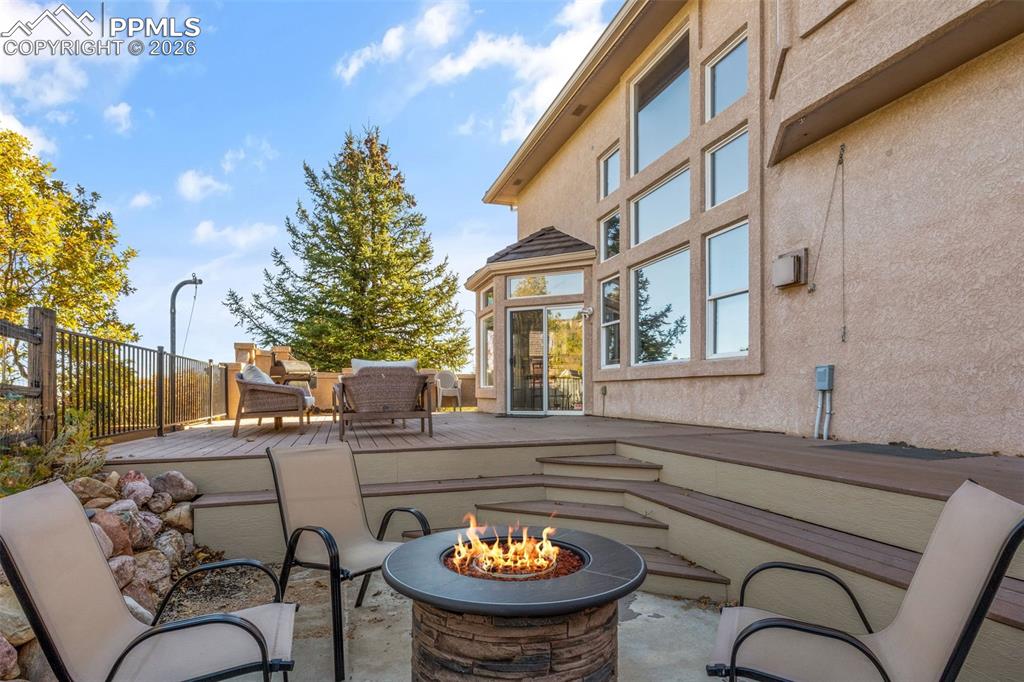 View of patio / terrace featuring a wooden deck and a fire pit