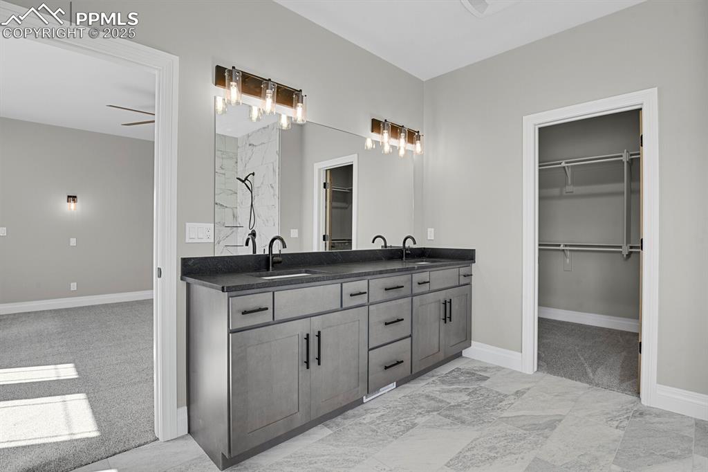 Double vanity and view of walk-in closet