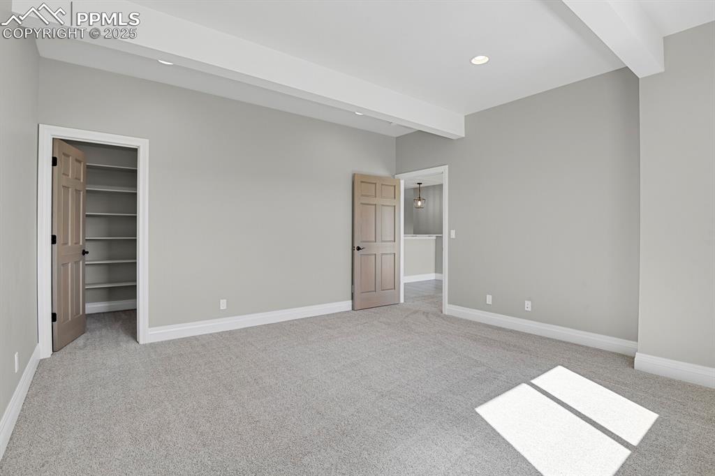 Bedroom #3 view of walk-in closet with built-in shelves