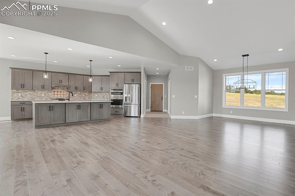 Kitchen and dining area view from fireplace.  Door at the far end is the garage entrance