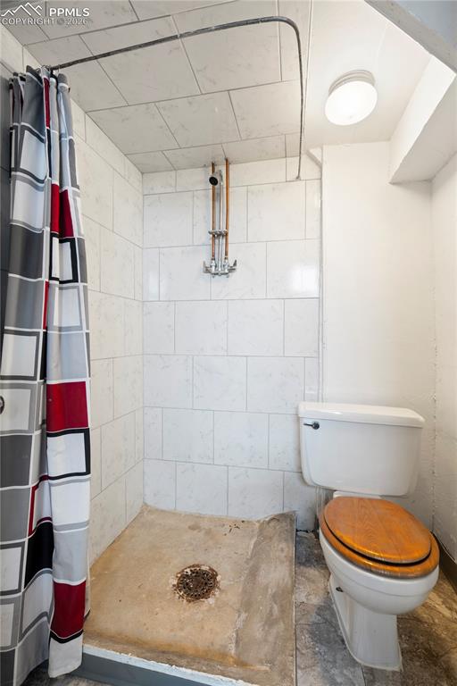 Bathroom with a stall shower and toilet