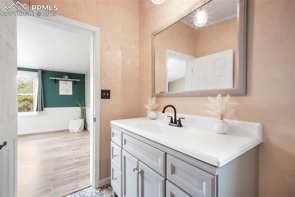 Bathroom featuring vanity and light wood-style floors