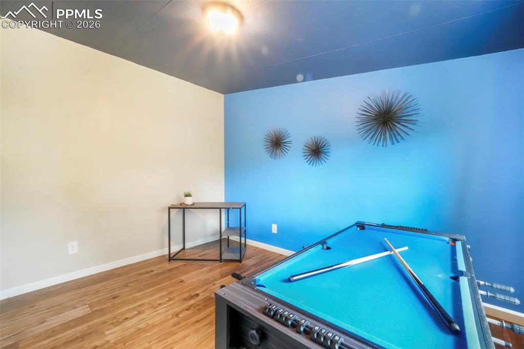 Game room featuring baseboards and wood finished floors