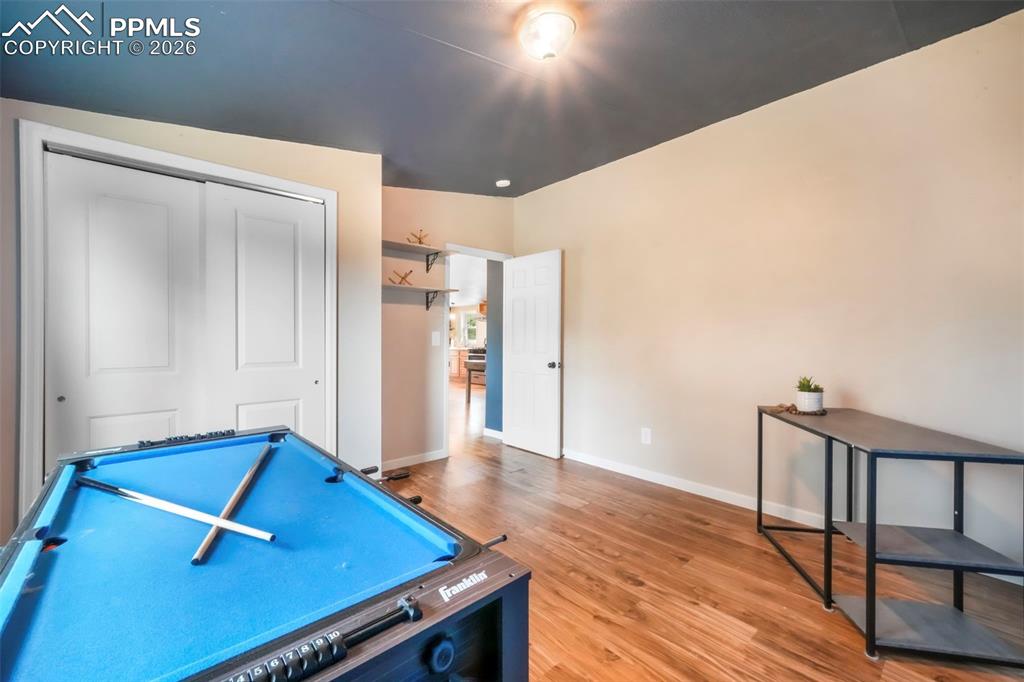 Rec room featuring light wood-type flooring and baseboards