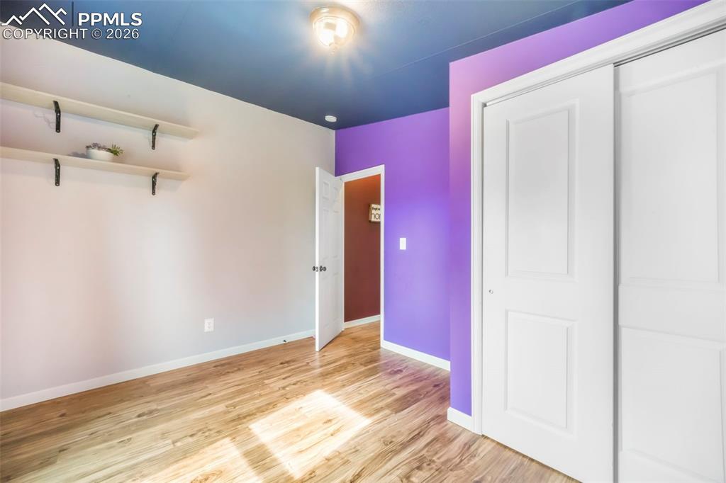 Unfurnished bedroom with light wood-style flooring and a closet