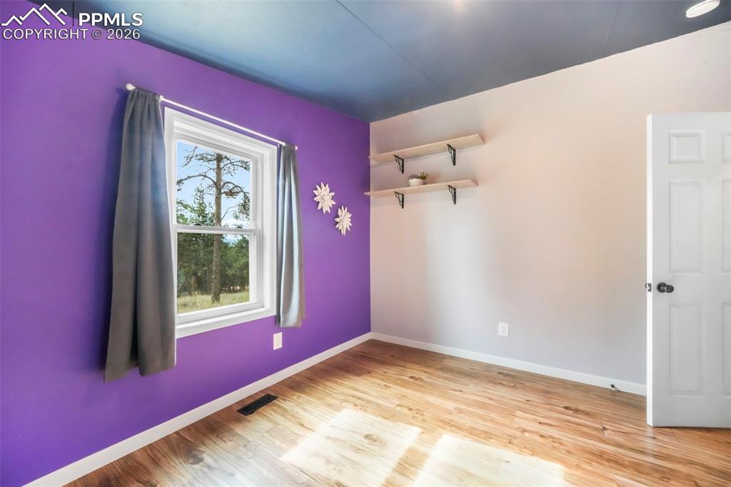 Unfurnished room featuring baseboards and light wood finished floors