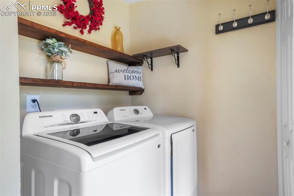 Laundry area with washer and clothes dryer