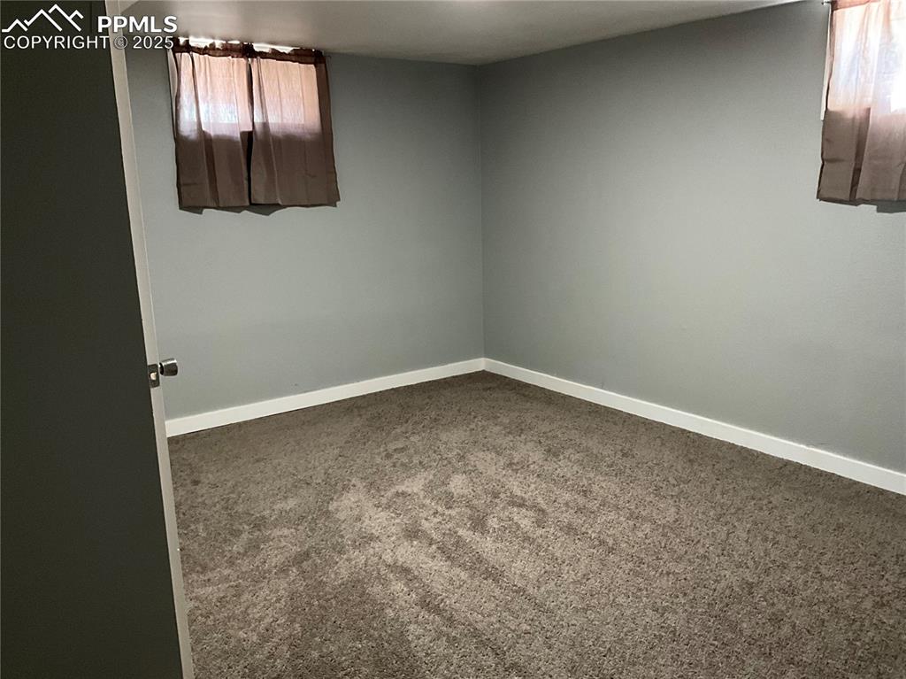 Unfurnished room with carpet floors and baseboards