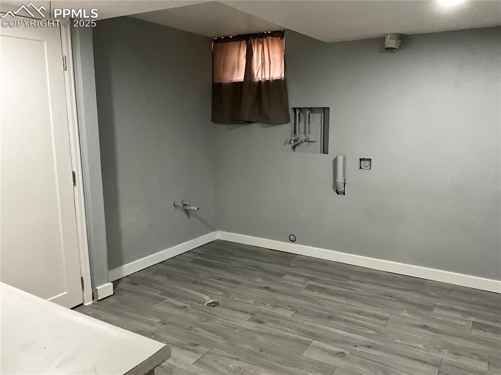 Laundry area featuring light wood-style floors, cabinet space, and hookup for a washing machine