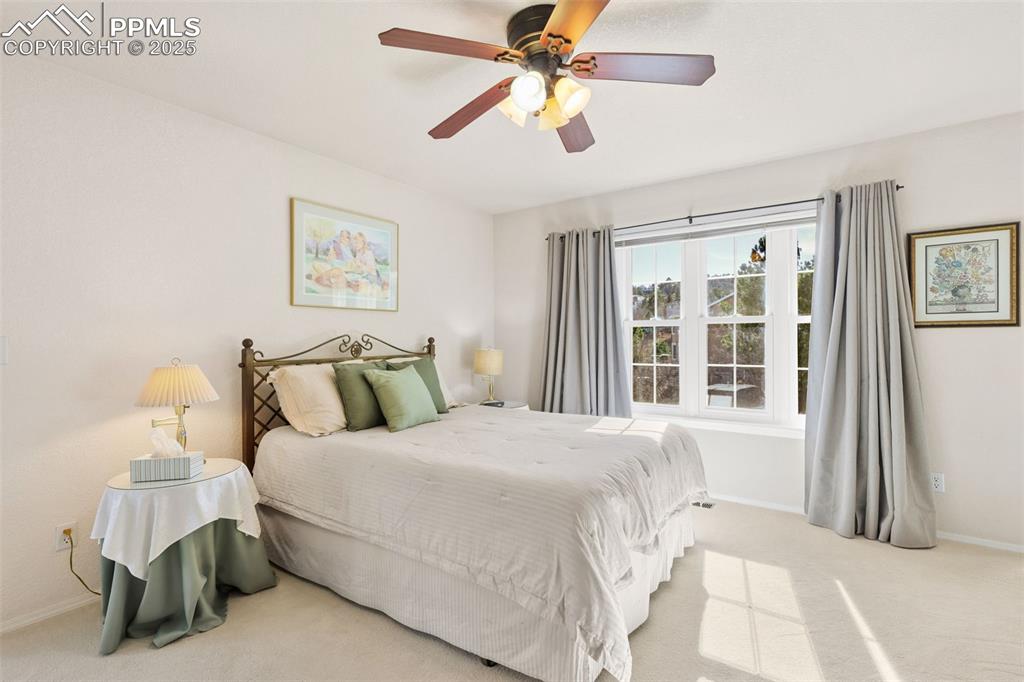 Bedroom with carpet floors and a ceiling fan