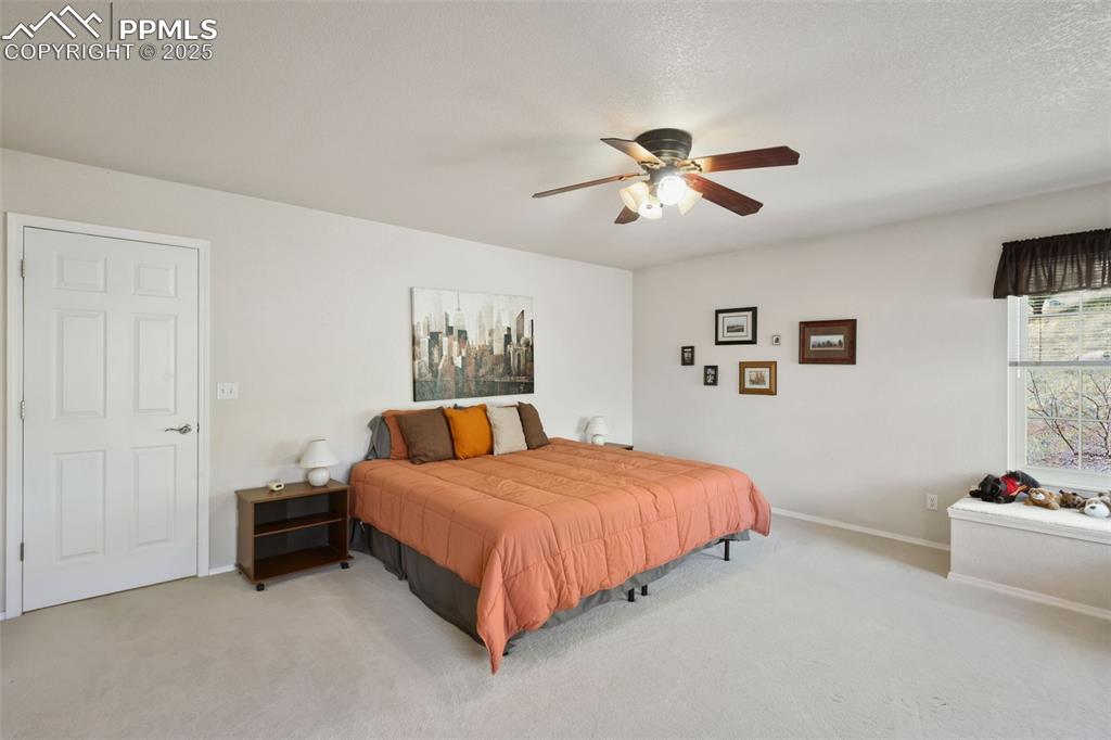 Bedroom with carpet flooring and a ceiling fan
