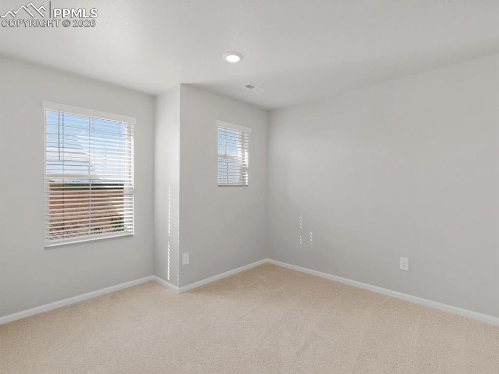 Unfurnished room featuring light colored carpet and recessed lighting
