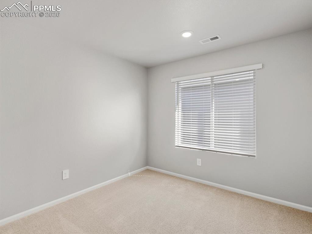 Empty room with carpet floors and recessed lighting