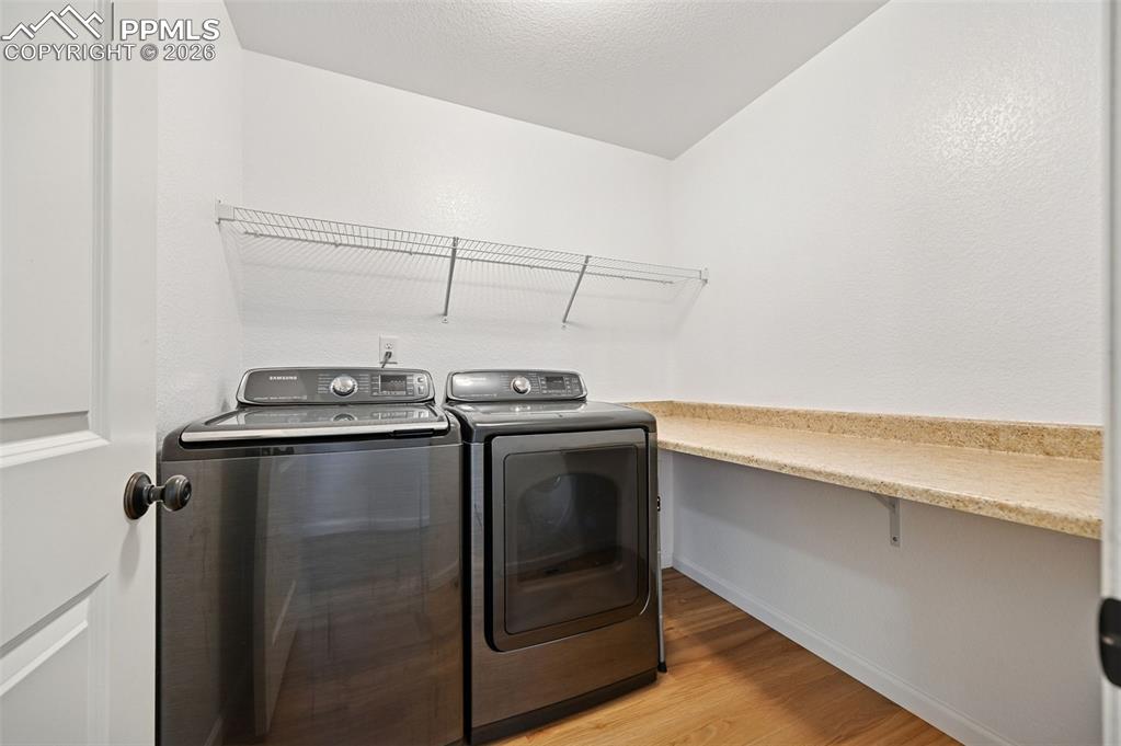 upstairs laundry room with folding table
