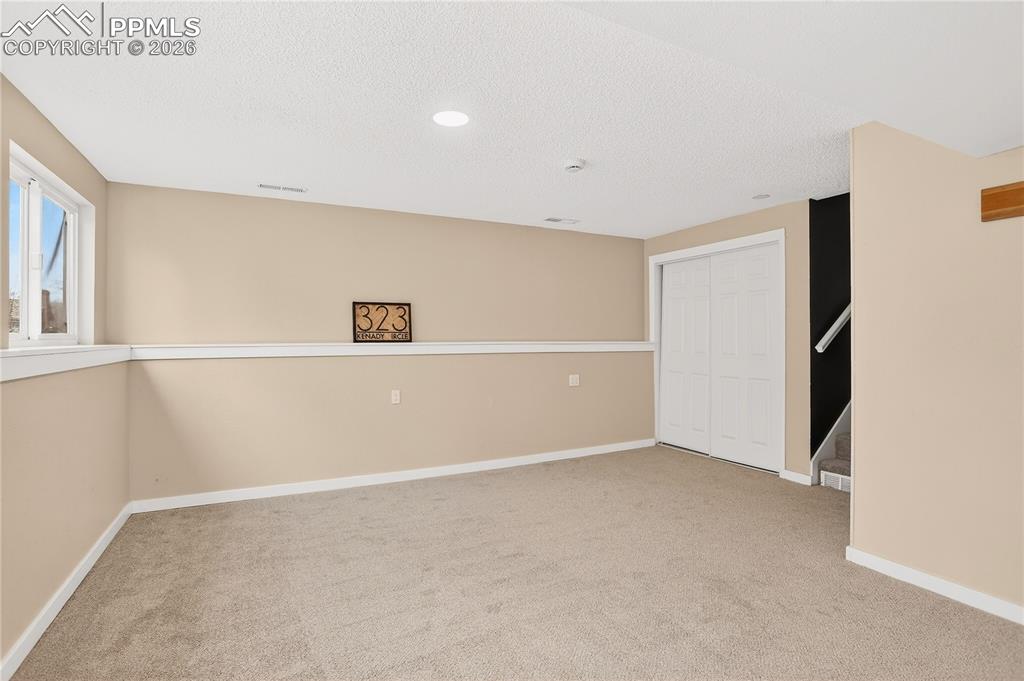 Spacious lower level flex area with closet storage.