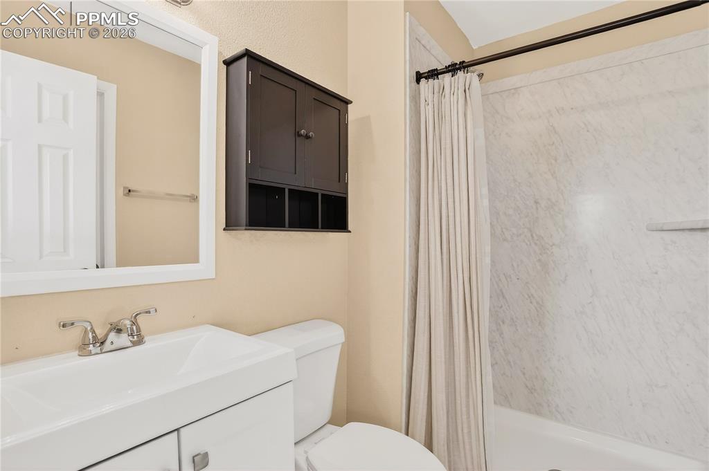Primary bathroom featuring an updated vanity and walk-in shower.