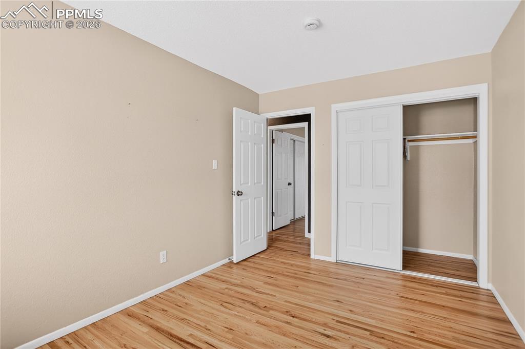 Second bedroom with hardwood flooring.