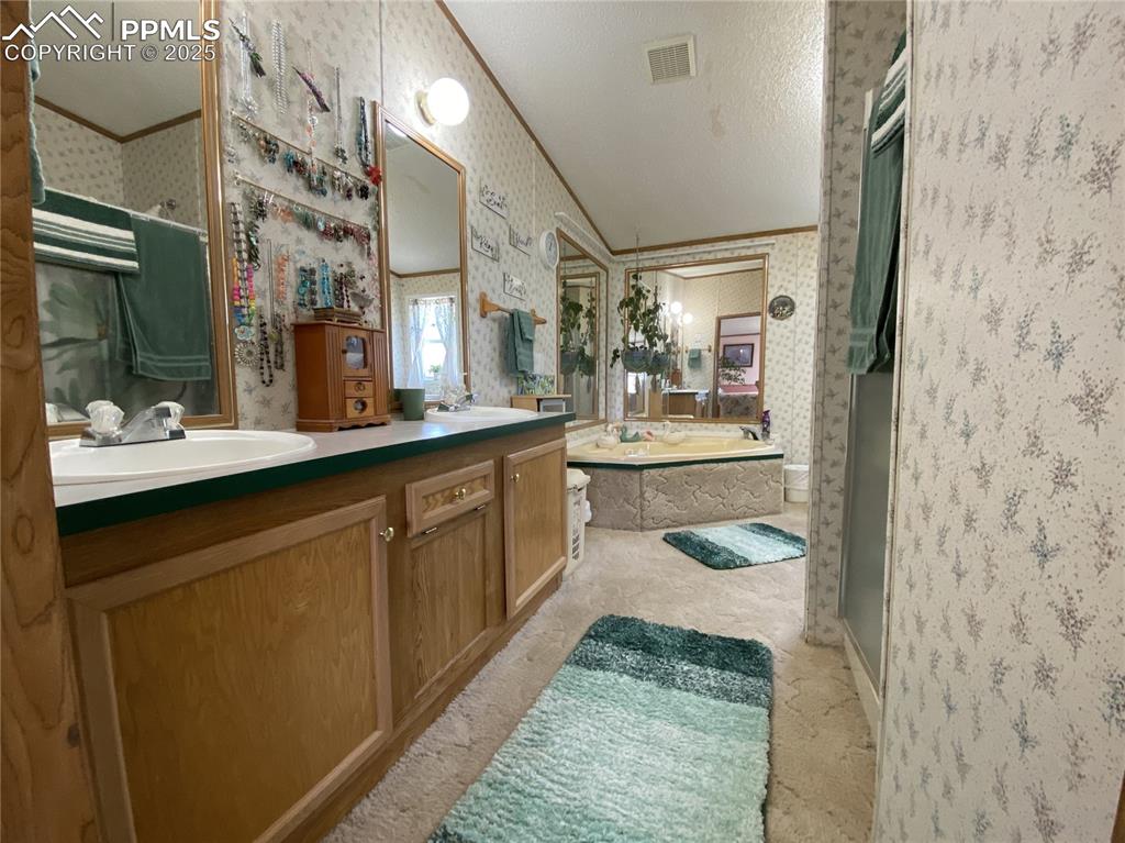 Spacious primary bathroom featuring a luxurious 5-piece design
