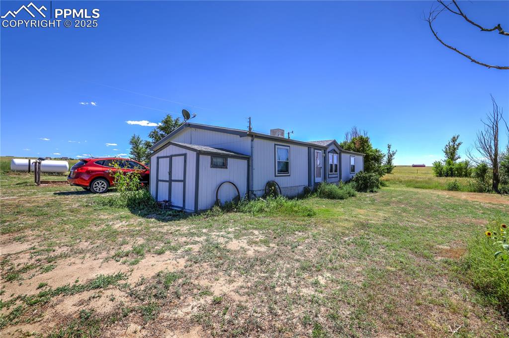 Charming front view of the home showcasing Colorado country living and expansive acreage