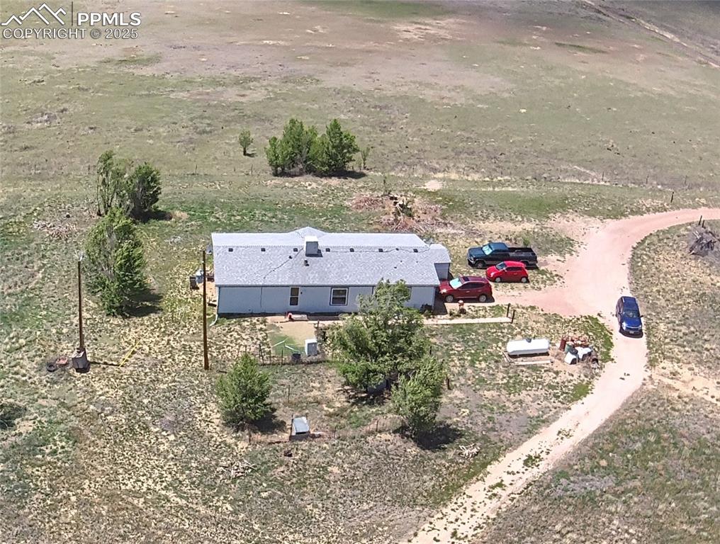 Bird’s-eye view highlighting the home, open spaces, and surrounding Colorado scenery