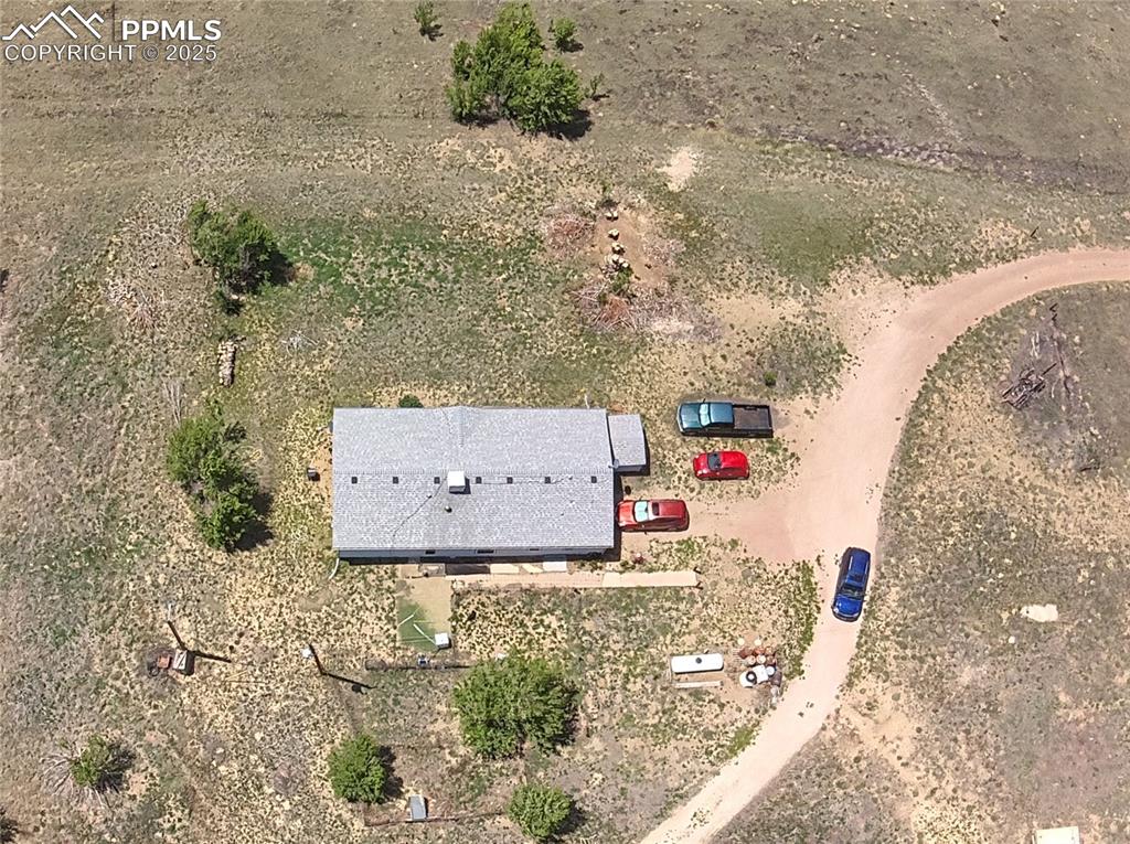 Expansive aerial view showing the home and surrounding rural Colorado scenery