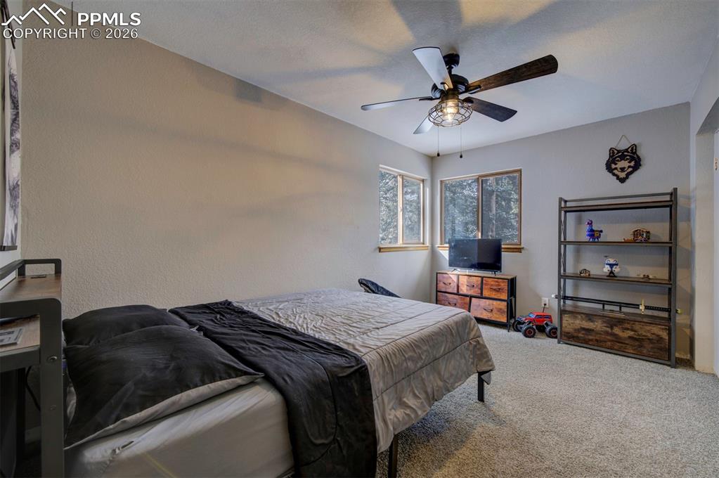 Bedroom featuring carpet floors and ceiling fan