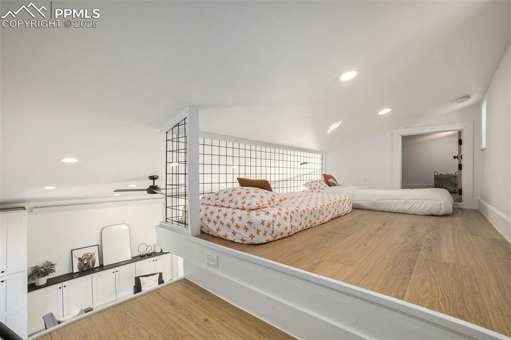 Bedroom featuring recessed lighting, light wood-style floors, and lofted ceiling
