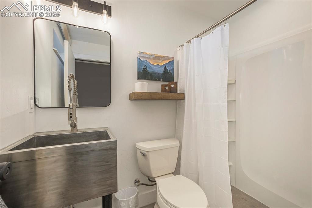 Bathroom with a shower with shower curtain and vanity