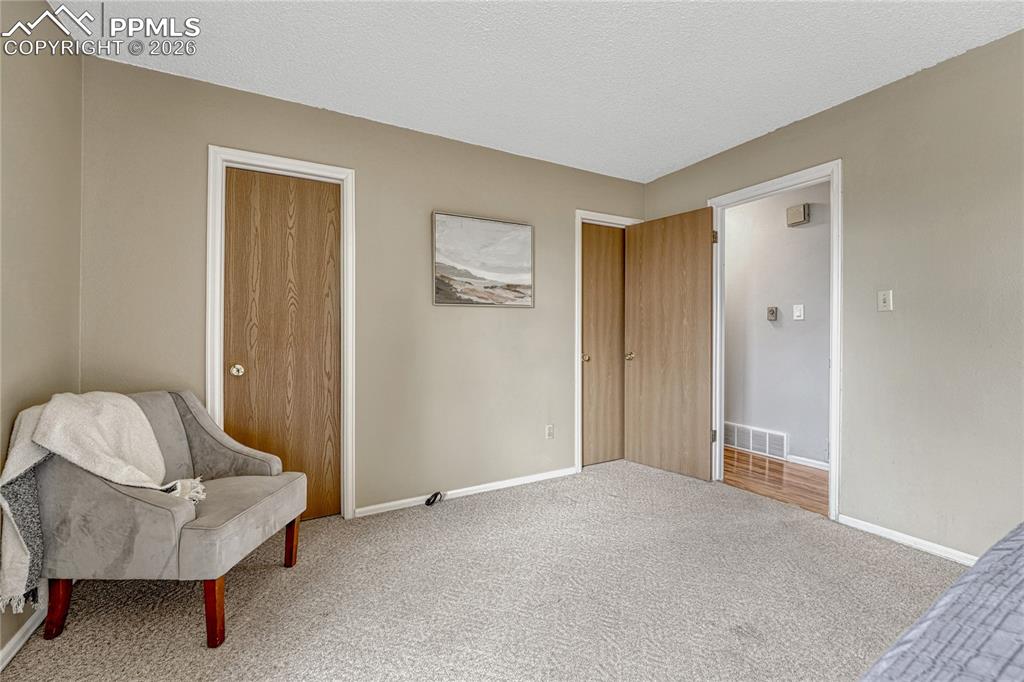 Primary bedroom with door to full bathroom and walk in closet