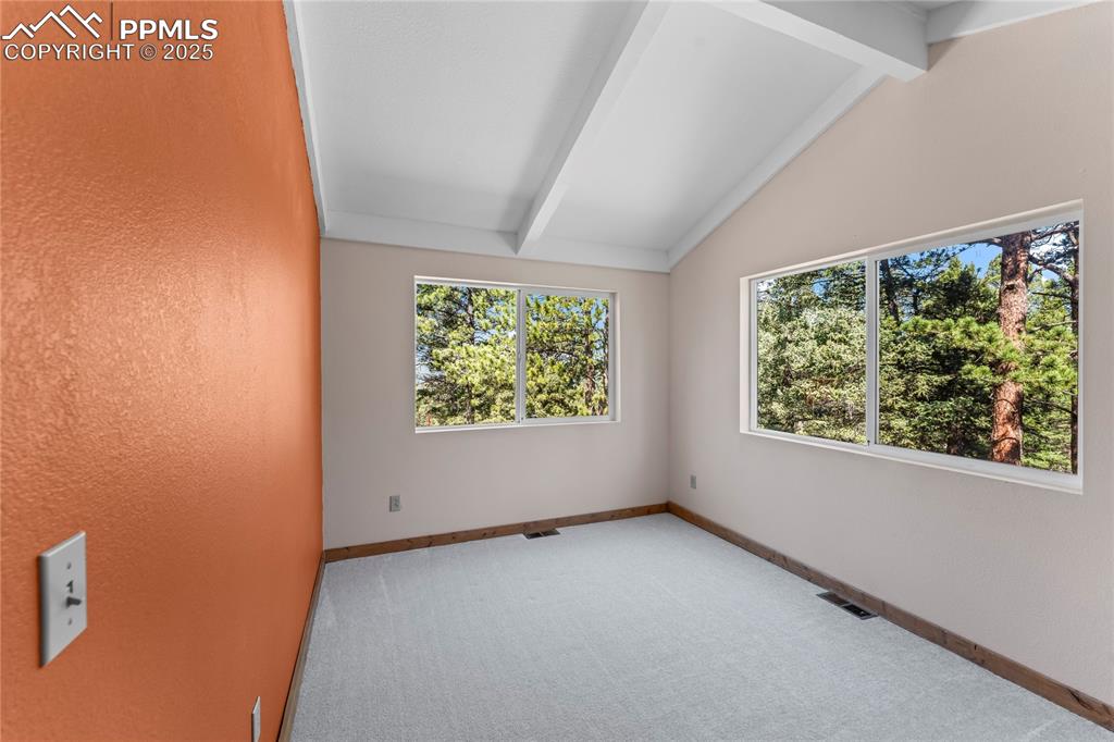 Bedroom with carpet floors and large windows