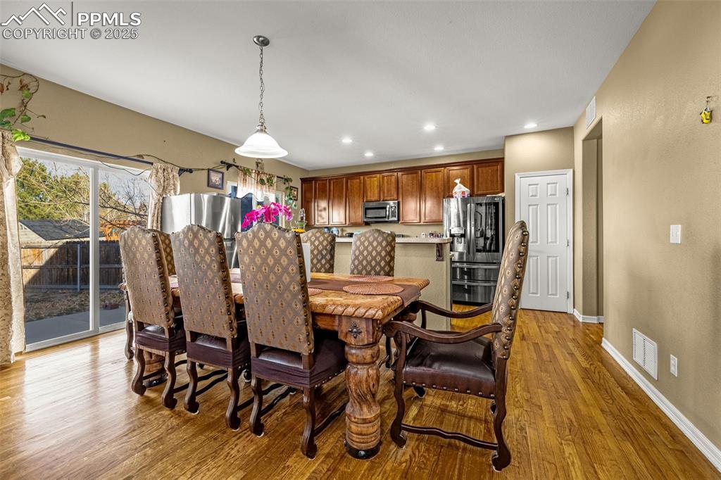 Dining space featuring light wood-style flooring and recessed lighting
