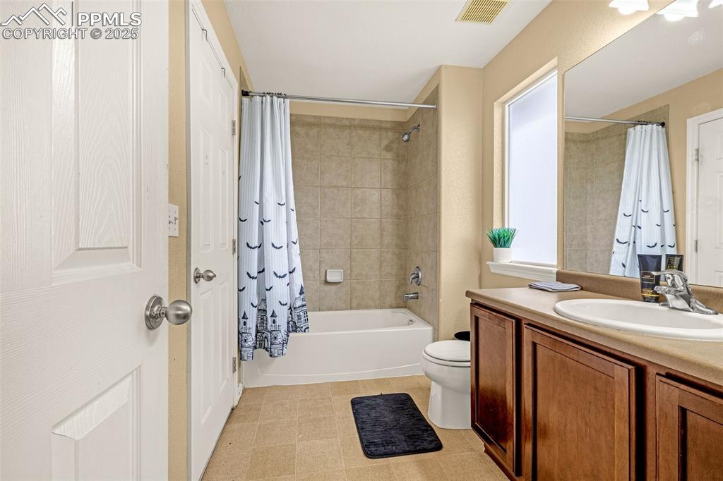 Full bath featuring vanity and shower / tub combo
