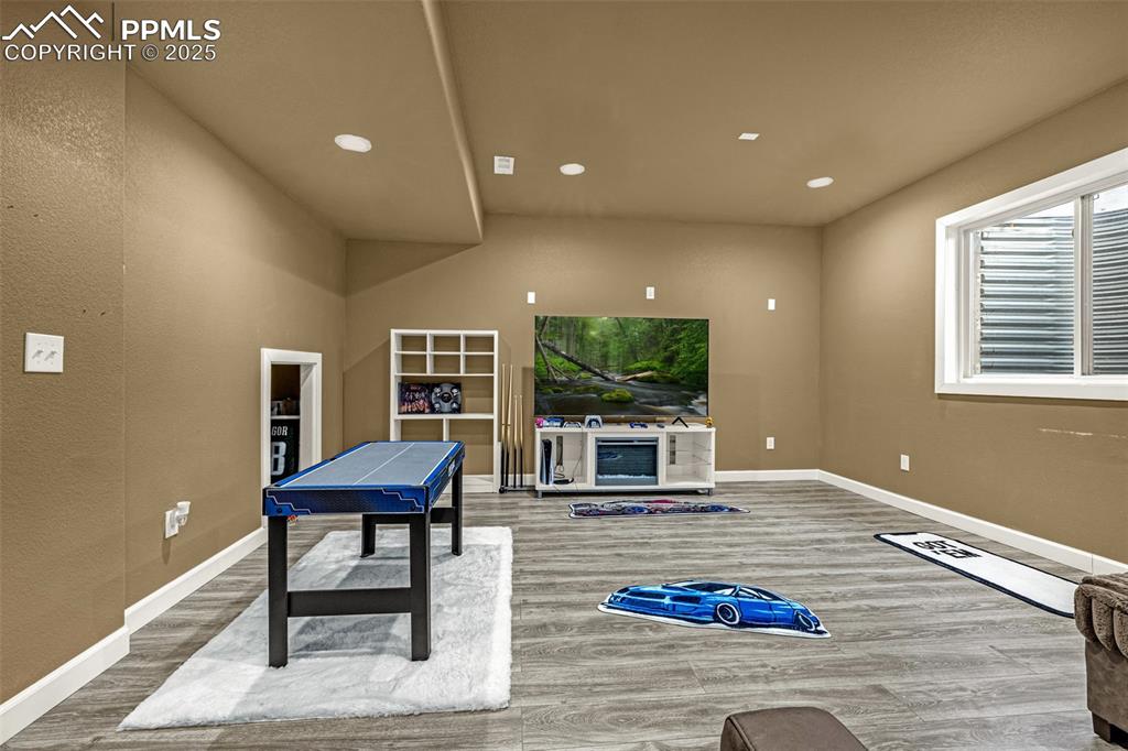 Rec room featuring wood finished floors and recessed lighting