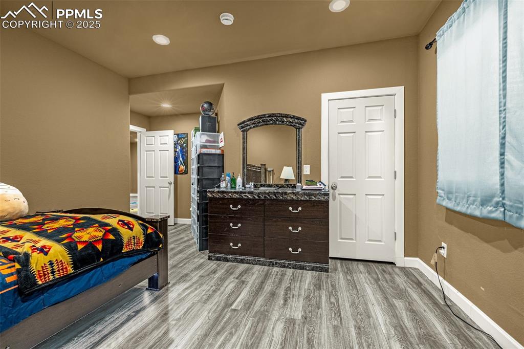 Bedroom with light wood-style flooring and recessed lighting