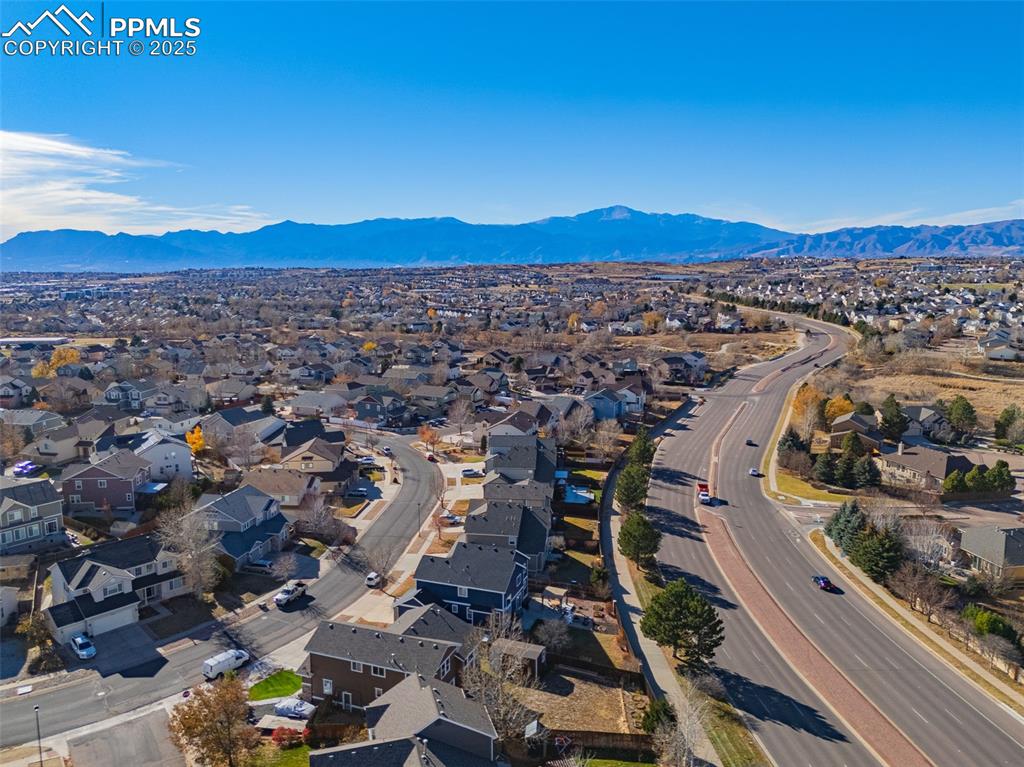 Aerial perspective of suburban area with a mountainous background
