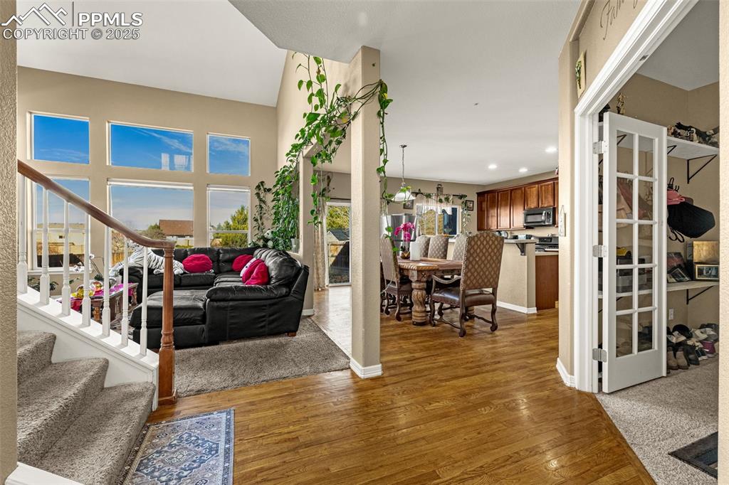 Entryway with stairs, dark wood finished floors, and recessed lighting