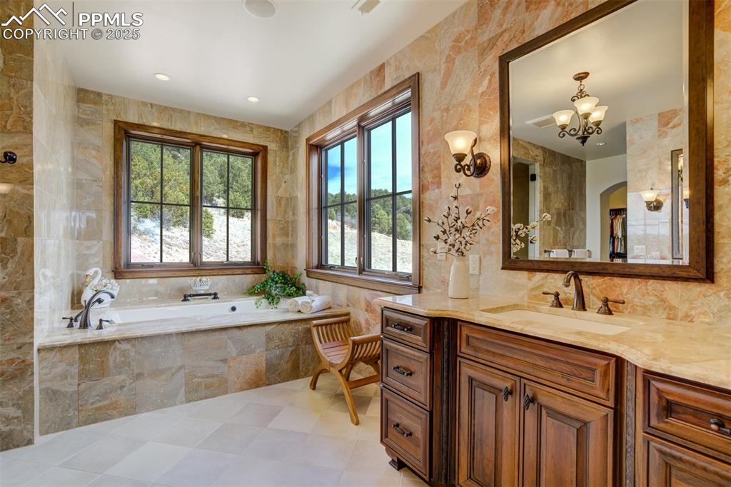 Primary bathroom with soaking tub, 2 separate sinks & floor to ceiling marble