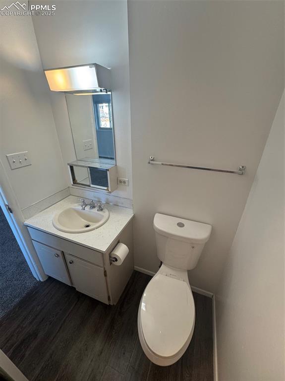 Bathroom featuring vanity and dark wood finished floors