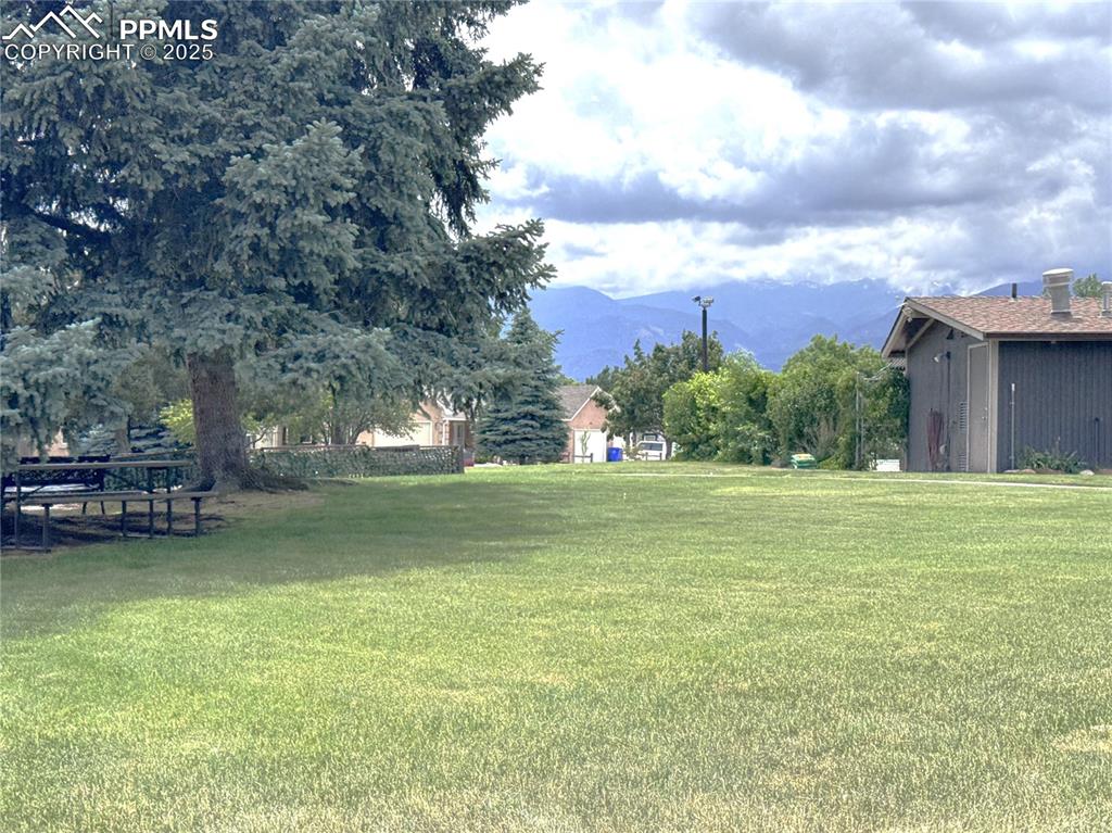 View of grassy yard featuring a mountain view