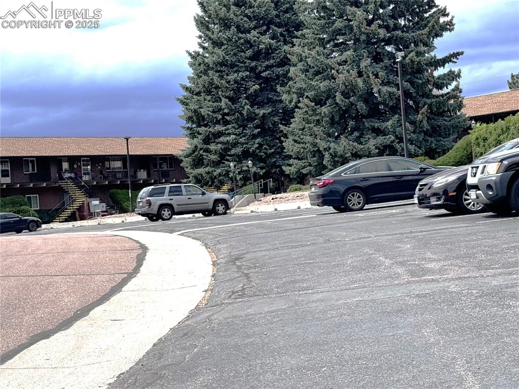 View of asphalt road featuring street lighting